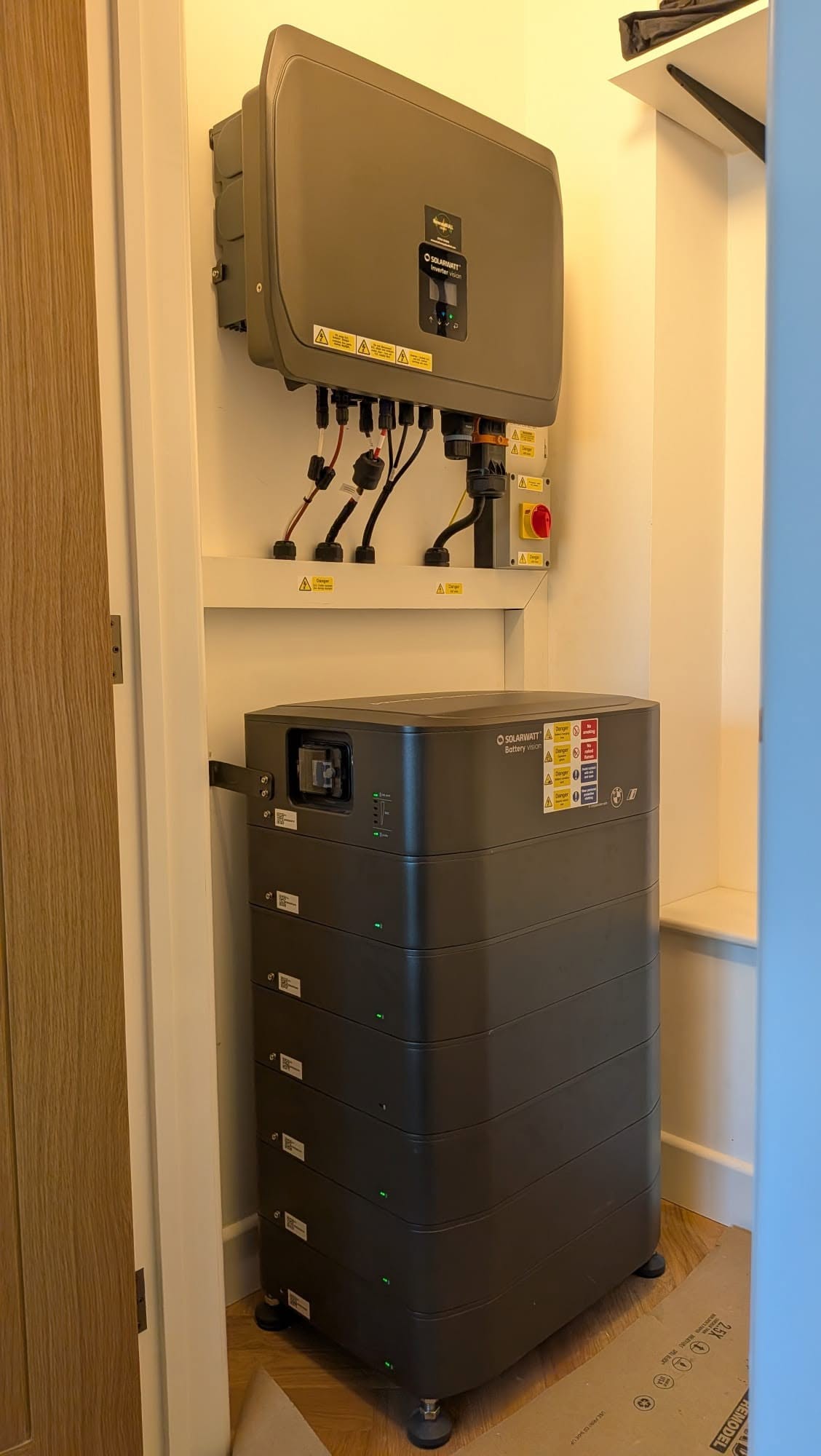 Solarwatt inverter and stacked battery storage installed in a home utility space.