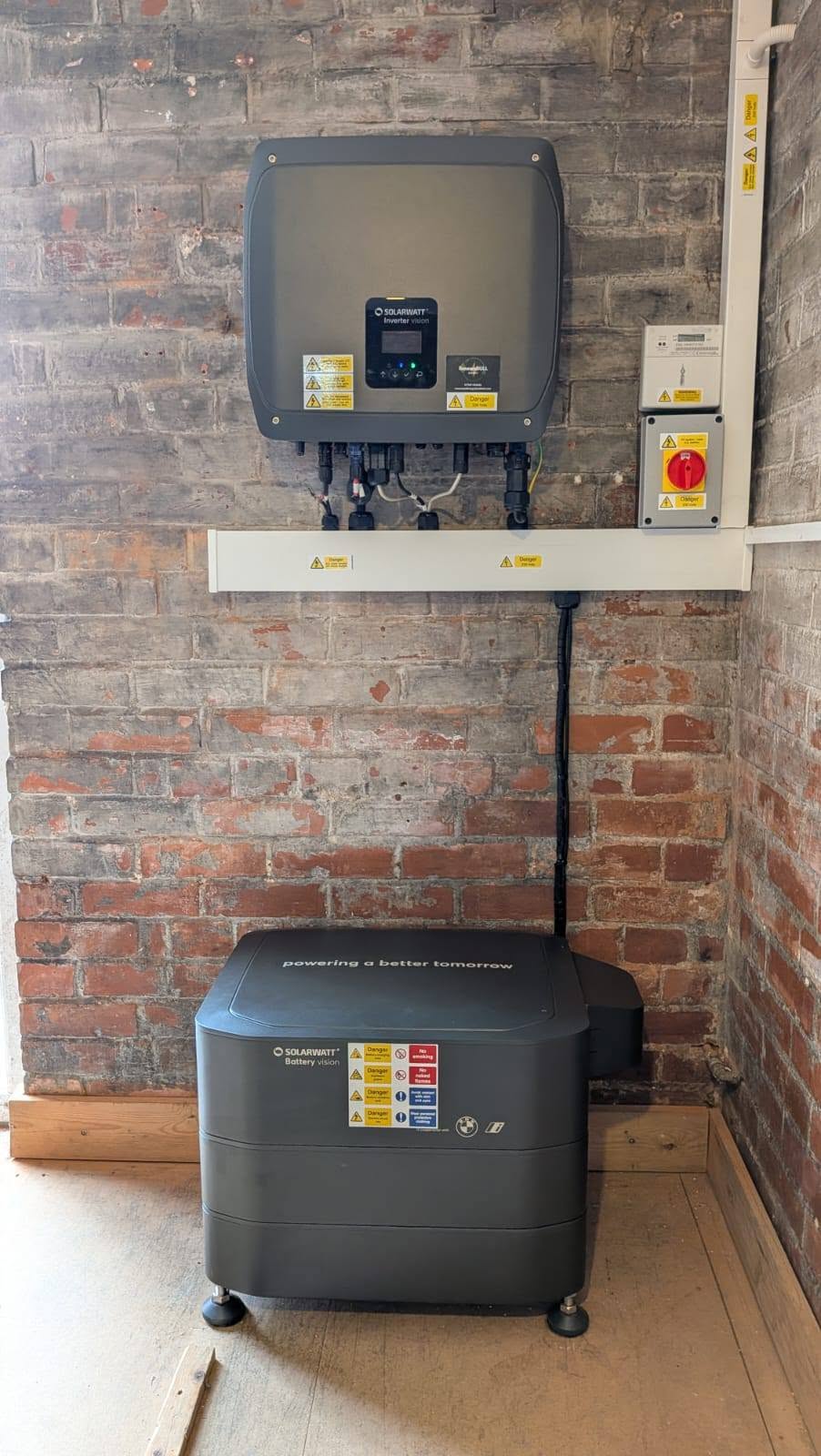 A Solarwatt inverter and battery storage system installed in a home's utility space.
